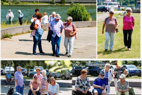 Teilnehmer spazieren am Rhein