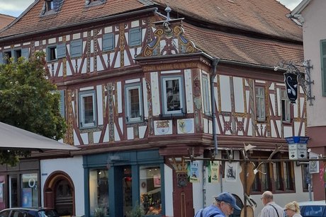 Ein dreist&ouml;ckiges Haus mit aufwendigem Fachwerk. Vorne ist ein Erker.