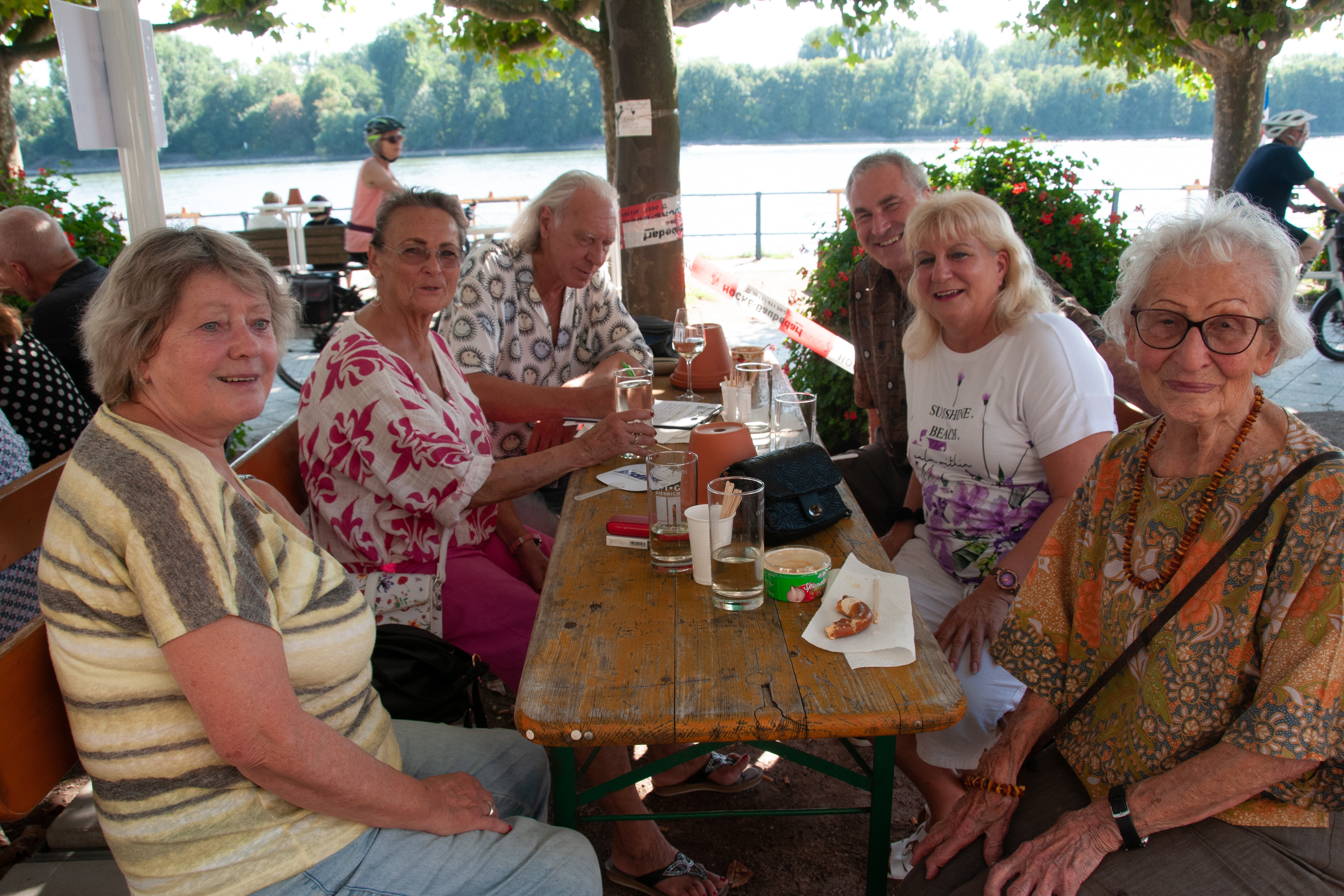 Mitglieder an den Tischen am Weinstand Mitglieder sitzen an Tischen und genießen ein gutes Gläschen Wein und die gesellige Atmosphäre